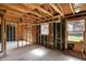 Unfinished living room highlighting the framing and a window with natural light at 11625 Rolling Springs Dr, Carmel, IN 46033