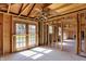 Unfinished living room with a ceiling fan, exposed wood framing, and a view into other rooms at 11625 Rolling Springs Dr, Carmel, IN 46033