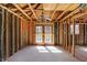 Unfinished living room featuring exposed framework, natural light, and a ceiling fan at 11625 Rolling Springs Dr, Carmel, IN 46033