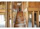 Unfinished wooden staircase between floors showing an opportunity for customization and architectural design at 11625 Rolling Springs Dr, Carmel, IN 46033