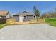 Rear exterior view with fresh deck and gravel area near a home at 1217 W 6Th St, Anderson, IN 46016