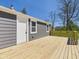 Fresh backyard deck, ready for entertaining, has white door to home at 1217 W 6Th St, Anderson, IN 46016