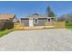 Exterior view of home with fresh backyard deck and gravel area at 1217 W 6Th St, Anderson, IN 46016