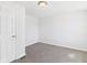 Neutral bedroom features carpet and a bright white door at 1217 W 6Th St, Anderson, IN 46016