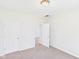 Neutral bedroom features carpet, two white doors, and light paint at 1217 W 6Th St, Anderson, IN 46016