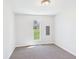 Neutral bedroom featuring carpet, light walls, a window with exterior view, and light fixture at 1217 W 6Th St, Anderson, IN 46016