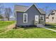 Charming gray home with a well-maintained lawn and inviting walkway leading to the front door at 1217 W 6Th St, Anderson, IN 46016