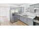 Modern kitchen with gray cabinets, stainless steel appliances, and sleek countertops; wood floors at 1217 W 6Th St, Anderson, IN 46016