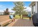 Inviting backyard featuring a wood deck with benches and blue decorative pillows at 1315 Hazy Falls Blvd, Westfield, IN 46074