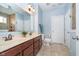 Bathroom with dual sinks, a vanity with dark wood cabinets, and a separate tiled shower at 1315 Hazy Falls Blvd, Westfield, IN 46074