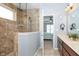 Light-filled bathroom featuring a glass shower, double sink vanity, and ensuite access to bedroom at 1315 Hazy Falls Blvd, Westfield, IN 46074