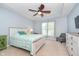 Primary bedroom features a tray ceiling, ceiling fan, and carpeted floors with a window overlooking the yard at 1315 Hazy Falls Blvd, Westfield, IN 46074