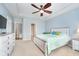 Comfortable bedroom featuring tray ceiling, fan, and light blue walls, providing a serene and airy atmosphere at 1315 Hazy Falls Blvd, Westfield, IN 46074