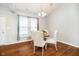 Cozy dining room featuring hardwood floors, a chandelier, and natural light from a window at 1315 Hazy Falls Blvd, Westfield, IN 46074