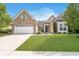Charming brick home featuring a well-manicured lawn, two-car garage, and inviting curb appeal at 1315 Hazy Falls Blvd, Westfield, IN 46074