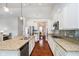 Gourmet kitchen with granite counters, stainless appliances and hardwood floors overlooks an adjacent dining area at 1315 Hazy Falls Blvd, Westfield, IN 46074