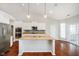 Bright kitchen features granite countertops, stainless steel appliances and a large central island with a sink at 1315 Hazy Falls Blvd, Westfield, IN 46074
