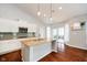 Kitchen with granite countertops, an island with sink, modern cabinets, and sliding doors leading to outdoor space at 1315 Hazy Falls Blvd, Westfield, IN 46074