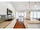 Well-lit kitchen boasts granite counters, modern appliances, and an open layout, enhanced by hardwood floors at 1315 Hazy Falls Blvd, Westfield, IN 46074