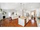 Open concept living space with fireplace, hardwood floors, and gourmet kitchen with stainless steel appliances at 1315 Hazy Falls Blvd, Westfield, IN 46074