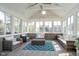 Bright sunroom with vaulted ceilings, a ceiling fan, and walls of windows overlooking backyard at 1315 Hazy Falls Blvd, Westfield, IN 46074