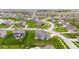 This aerial view showcases well manicured lawns and a patio in a quiet and friendly neighborhood at 1334 Winfield Way, Greenwood, IN 46143
