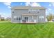 Spacious backyard with well-kept lawn and deck, perfect for outdoor activities at 1334 Winfield Way, Greenwood, IN 46143