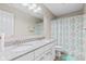 Bathroom featuring a double sink vanity, large mirror, and a shower/tub with patterned curtain at 1334 Winfield Way, Greenwood, IN 46143