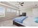 Cozy bedroom with a ceiling fan, three large windows and a comfortable bed at 1334 Winfield Way, Greenwood, IN 46143