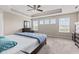 Bright bedroom with a tray ceiling, ceiling fan and three windows providing great natural light at 1334 Winfield Way, Greenwood, IN 46143