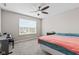 Bright bedroom featuring a ceiling fan, large window and musical keyboard at 1334 Winfield Way, Greenwood, IN 46143
