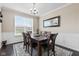 Dining room featuring modern lighting, wainscoting, and a large window offering ample natural light at 1334 Winfield Way, Greenwood, IN 46143