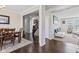 Dining area showing dark wood floors, a dining table, and an open view into the living spaces at 1334 Winfield Way, Greenwood, IN 46143