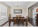 Dining room with wainscoting, wood table, chandelier, window with blinds, and a decorative rug at 1334 Winfield Way, Greenwood, IN 46143