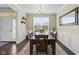 Dining room showing a wood table, chair set, wainscoting, modern chandelier, and ample natural light at 1334 Winfield Way, Greenwood, IN 46143
