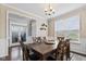 Traditional dining room with hardwood floors, chair rail molding, and a modern chandelier at 1334 Winfield Way, Greenwood, IN 46143
