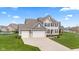 Inviting two-story home featuring a well-manicured lawn and a two-car garage at 1334 Winfield Way, Greenwood, IN 46143
