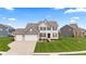 Beautiful two-story home with a manicured lawn, a three-car garage, and a classic brick and siding facade at 1334 Winfield Way, Greenwood, IN 46143