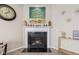Close-up of fireplace with mantle decor, wall art, and side table with gold accents at 1334 Winfield Way, Greenwood, IN 46143
