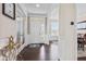 Bright and elegant foyer with hardwood floors, decorative wainscoting, and a view into the adjacent dining area at 1334 Winfield Way, Greenwood, IN 46143