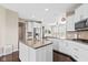 Well-lit kitchen with white cabinetry, stainless steel appliances, and granite countertops at 1334 Winfield Way, Greenwood, IN 46143