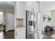 Stainless steel refrigerator with white cabinetry, granite countertop and mosaic backsplash at 1334 Winfield Way, Greenwood, IN 46143
