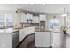 Bright kitchen features white cabinets, stainless steel appliances, granite countertops, and hardwood flooring at 1334 Winfield Way, Greenwood, IN 46143
