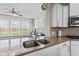 Close up of kitchen with stainless sink, granite countertops, white cabinetry and stainless appliances at 1334 Winfield Way, Greenwood, IN 46143