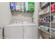 Bright laundry room with front load washer and dryer, and storage shelving at 1334 Winfield Way, Greenwood, IN 46143
