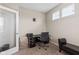 This well-lit home office features a black desk, comfortable chair, and neutral carpet at 1334 Winfield Way, Greenwood, IN 46143