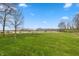 Lush backyard with expansive green space, perfect for outdoor activities and enjoying nature at 1502 N Matthews Rd, Greenwood, IN 46143