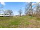 Expansive backyard with mature trees and partial fencing on a sunny day at 1502 N Matthews Rd, Greenwood, IN 46143