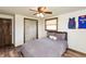 Comfortable bedroom with dark wood accents, ceiling fan, and a large window for natural light at 1502 N Matthews Rd, Greenwood, IN 46143