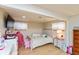 Comfortable bedroom with hardwood floors, built-in TV, and natural lighting at 1502 N Matthews Rd, Greenwood, IN 46143